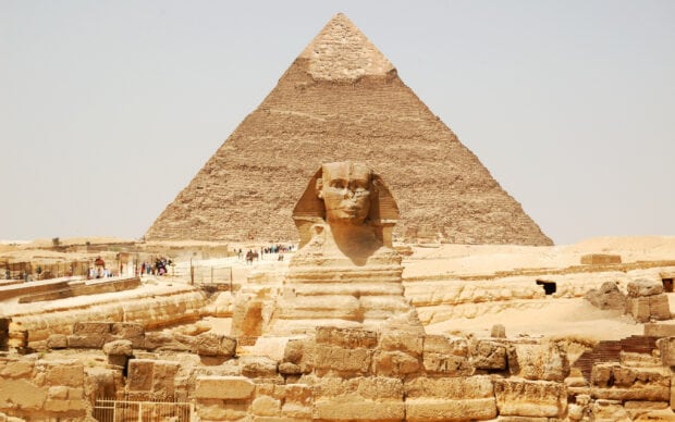 The Great Sphinx and ancient pyramids of Giza under a clear sky in Egypt