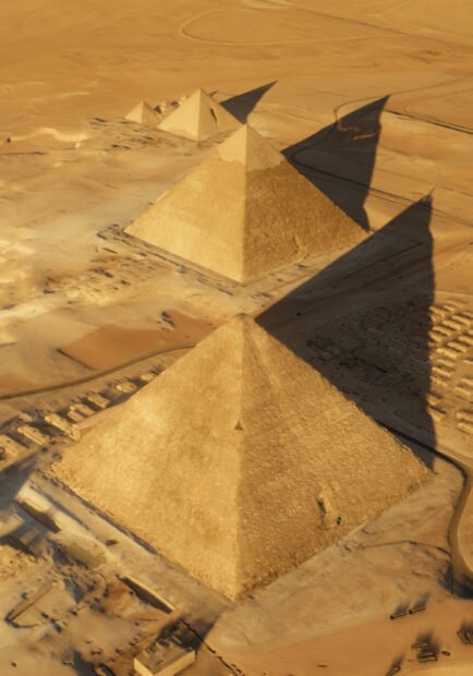 The largest pyramids of Giza casting long shadows over the desert sands