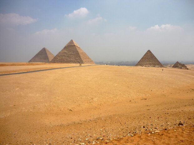 The ancient pyramids of Giza standing in the desert under a clear sky