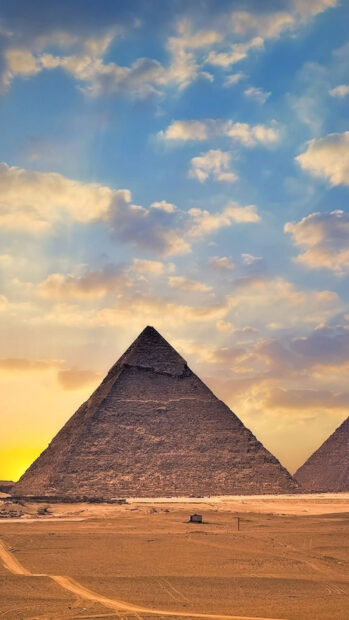 The Great Pyramid is standing tall under the vibrant desert sky