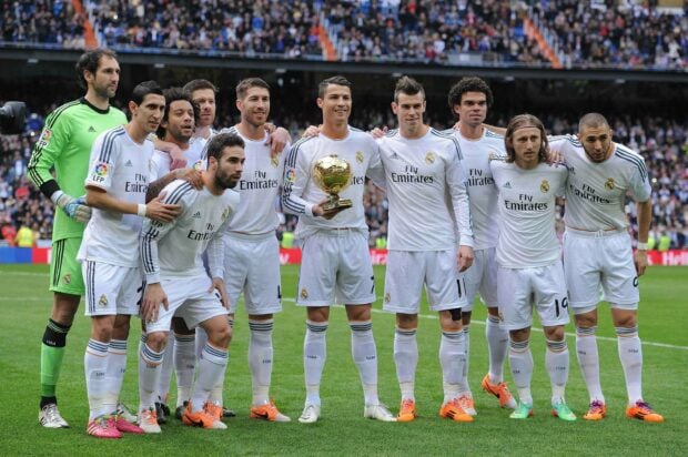 Real Madrid Cf players posing together on the football field before a match