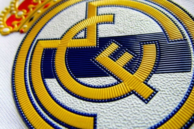Close up of Real Madrid Cf emblem on white fabric texture