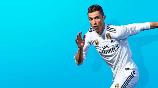 Cristiano Ronaldo in Real Madrid Cf kit running against a blue background