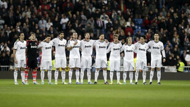 Real Madrid Cf players standing in line on the football field before a match