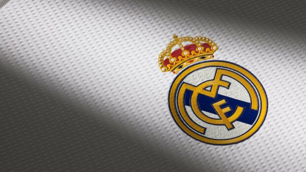 Real Madrid Cf logo embroidered on white textured fabric in high definition quality