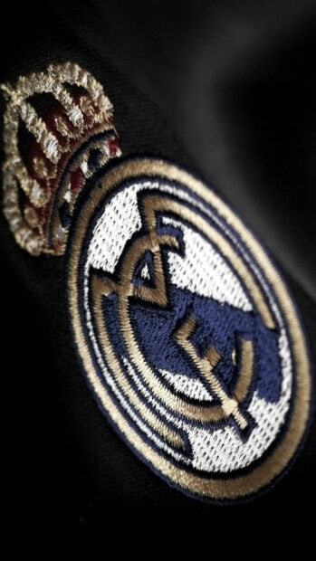Close up embroidery of Real Madrid Cf crest on black fabric background