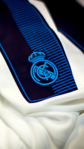 Real Madrid Cf emblem on a white fabric background with blue stripes