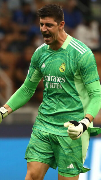 Real Madrid Cf player in green goalkeeper kit celebrating during the match