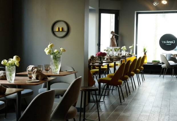 Modern restaurant interior with elegant tables and chairs and fresh flowers on tables