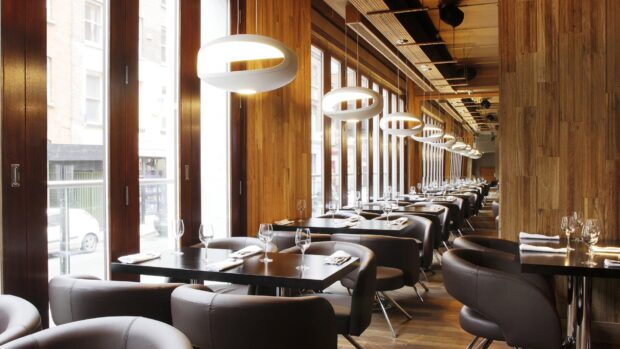 Modern restaurant interior with elegant tables and leather chairs in a stylish setting