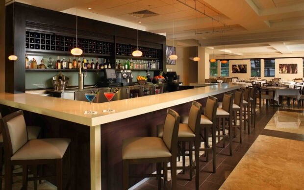 Modern restaurant interior with bar counter and elegant seating arrangement