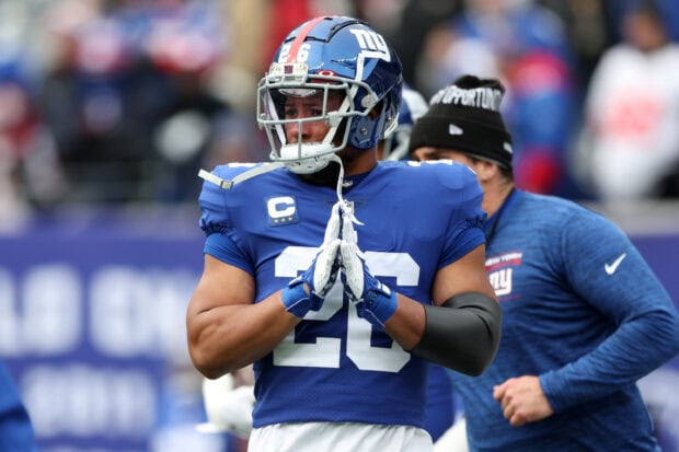 Saquon Barkley wearing a blue football uniform with number 26 preparing on the field before a game