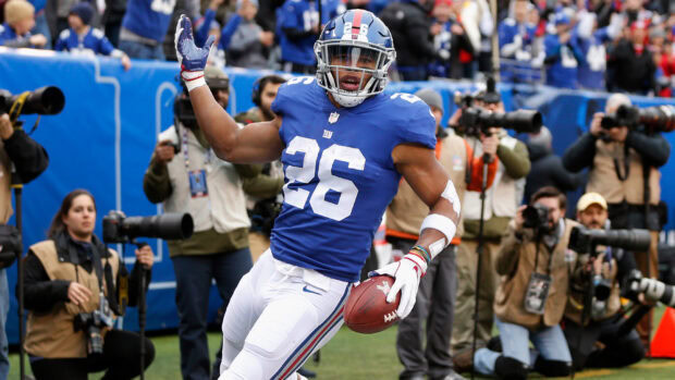 Saquon Barkley celebrating a touchdown during a football game on the field