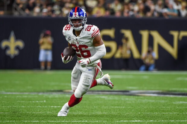 Saquon Barkley running with a football during an NFL game