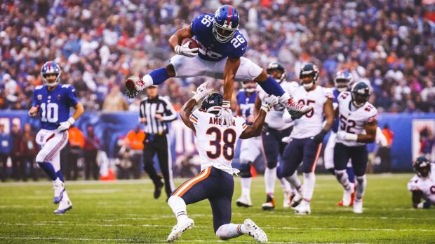 Saquon Barkley leaps over defender during football game in high action scene