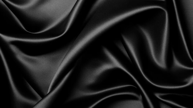 Smooth black satin texture with elegant folds and shiny surface
