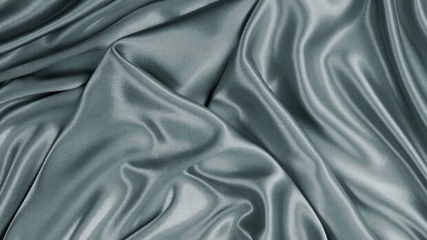 Smooth satin fabric texture with elegant folds and soft lighting effects