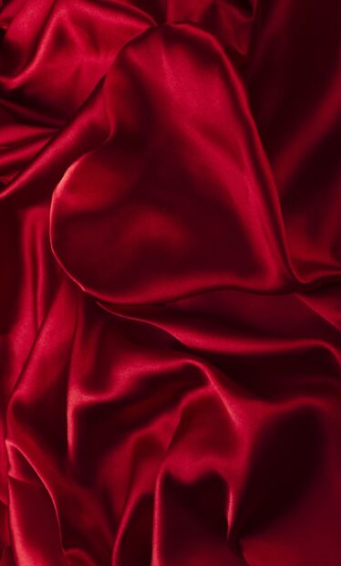 Smooth red satin fabric with elegant folds and soft texture