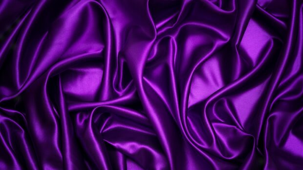 Luxurious purple satin fabric with smooth folds and silky texture