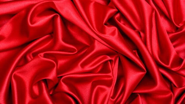Smooth red satin fabric with folds and soft texture in high quality