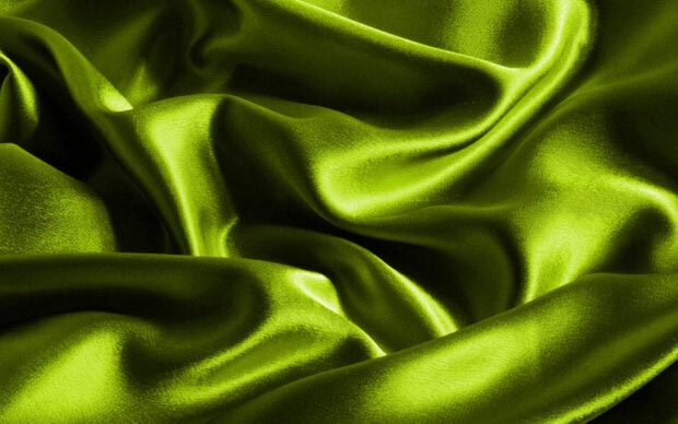 Smooth satin fabric with bright green color and shining texture