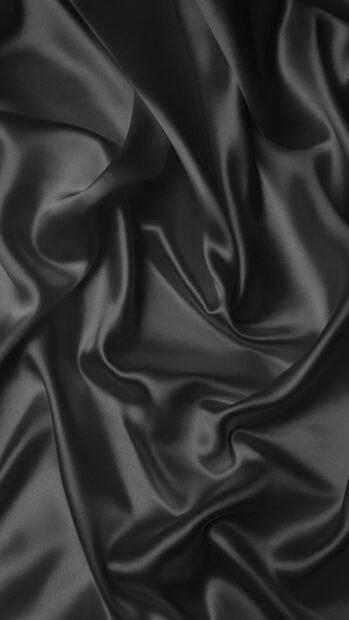 Smooth black satin fabric with elegant folds and shiny texture