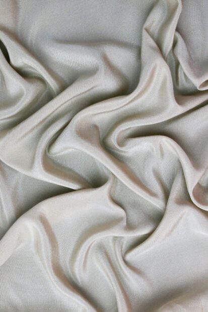 Smooth satin fabric texture with soft folds and elegant flow