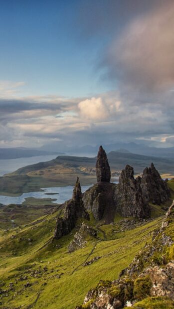 Tall rock formations and green hills in Scotland landscape