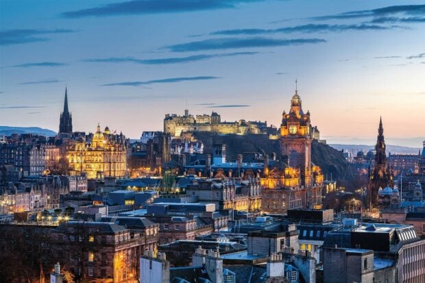 Historic Edinburgh cityscape with Scotland castle on a clear evening sky