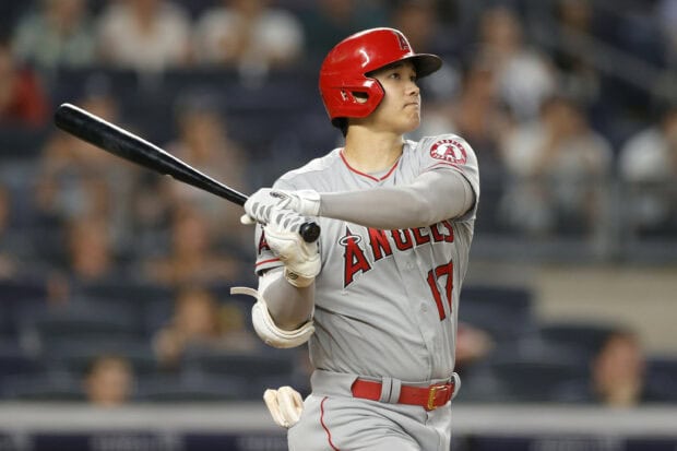 Shohei Ohtani in a baseball uniform swinging a bat during a game
