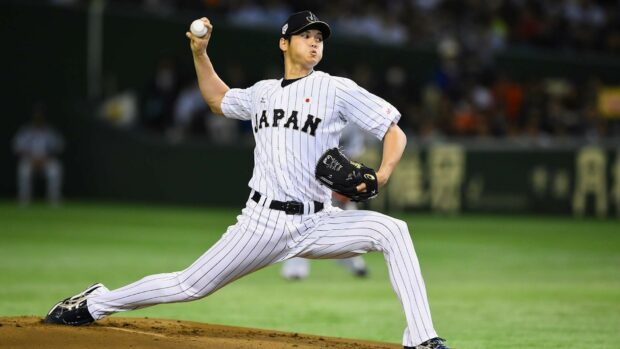 Shohei Ohtani pitching for Japan in a professional baseball game wearing a striped uniform