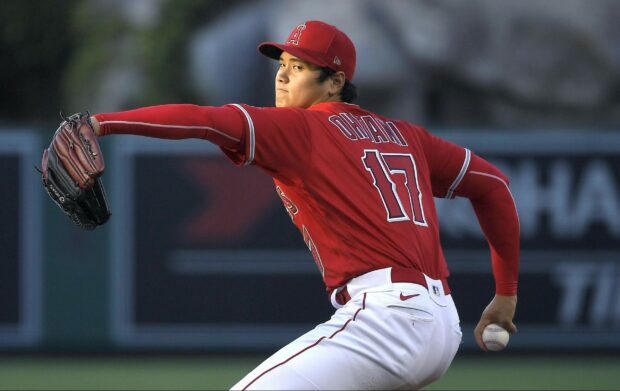Shohei Ohtani pitching in a red jersey with the number 17 on his back