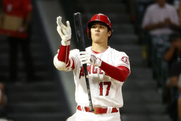 Shohei Ohtani preparing to bat during a baseball game wearing an Angels uniform