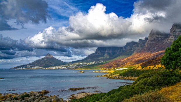 Stunning South Africa coastline with mountains and clouds on a bright day