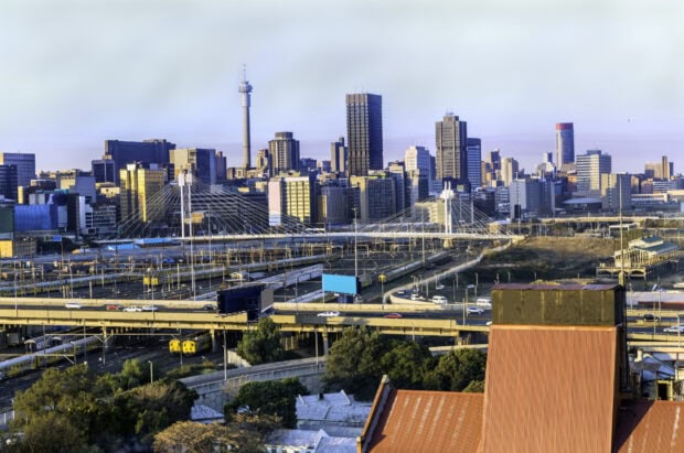 Johannesburg cityscape with urban skyline and green trees in South Africa