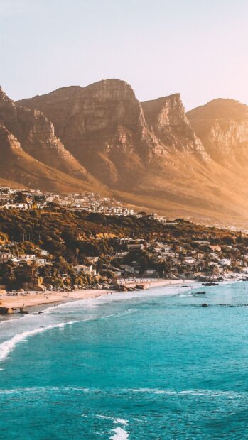 Coastal town with South Africa landscape and ocean waves at sunset