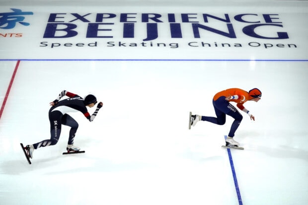 Two speed skating athletes compete on the ice during a speed skating China Open event