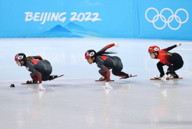 Female athletes competing in a speed skating race at the Beijing 2022 Winter Olympics
