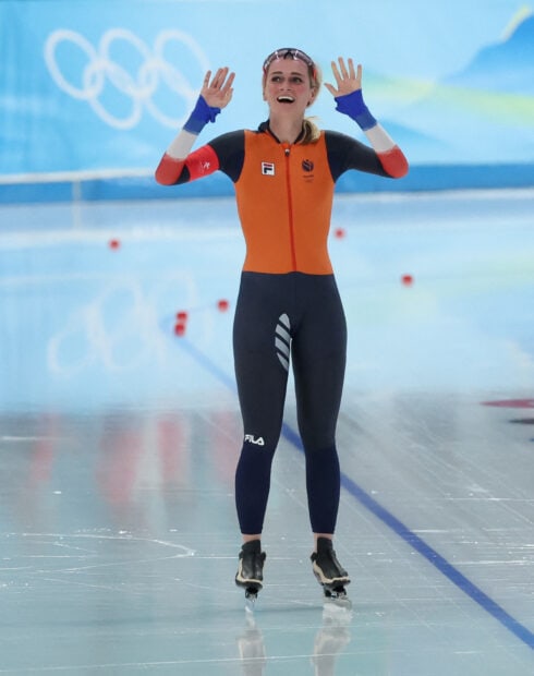 Female speed skater celebrating on ice during competition