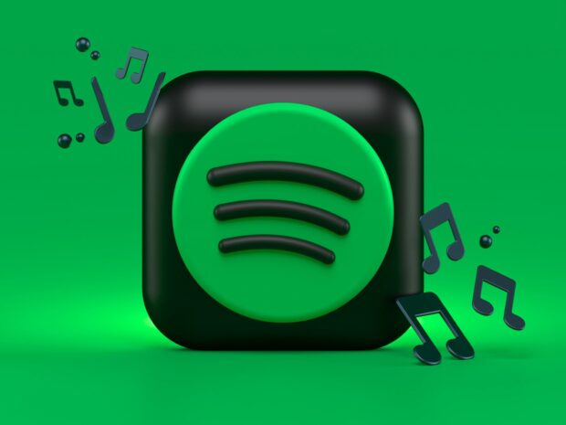 Spotify icon with music notes on a green background featuring Spotify design
