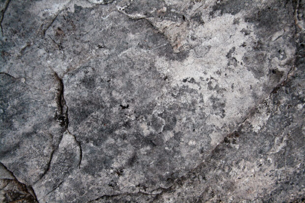 Close up of a natural stone texture with detailed rough surfaces and cracks