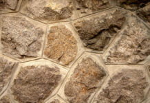 Rough stone texture with natural patterns and earthy tones on wall surface