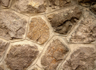 Rough stone texture with natural patterns and earthy tones on wall surface