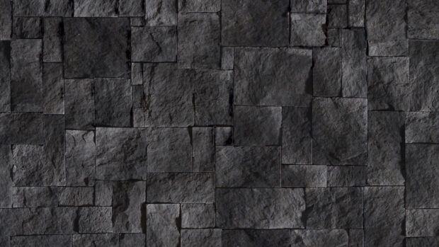 Dark gray stone texture wall with rough surface and rectangular pattern