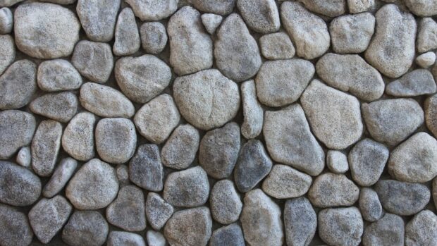 Close up of natural stone texture with various shapes and sizes forming a rough surface