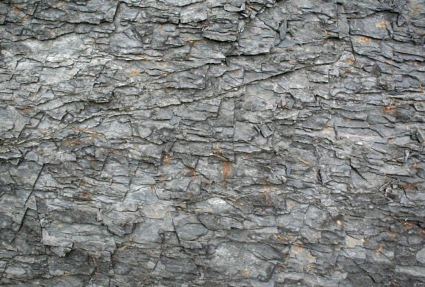 Close up of rough stone texture with natural cracks and layers