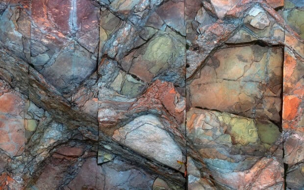 Colorful stone texture with natural cracks and layers