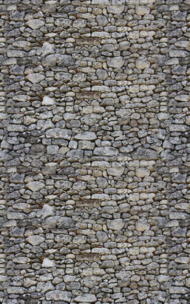 Rough stone texture creating a natural and rustic surface pattern on a wall
