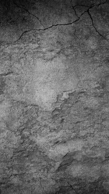 Rough stone texture with natural cracks and details on a dark surface