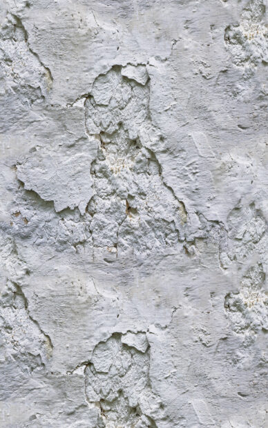 Rough stone texture with peeling paint details on a weathered surface